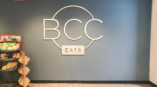 BCC Eats logo signage in store. 
