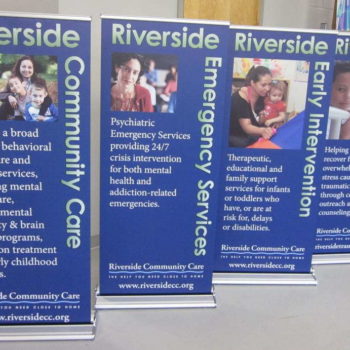 Standing signs advertising Riverside Community Care. 