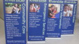 Pop-up Banner Four custom Standing signs advertising Riverside Community Care.