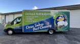 Custom full wrap on a commercial box truck featuring vibrant printed graphics for high-impact mobile advertising and brand visibility.