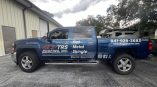 Commercial vehicle graphics combining a partial printed wrap with custom cut vinyl lettering and logos for professional mobile branding.