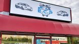 A large backlit sign installed on top of ECP Auto Repair in Cuyahoga Falls, Ohio.