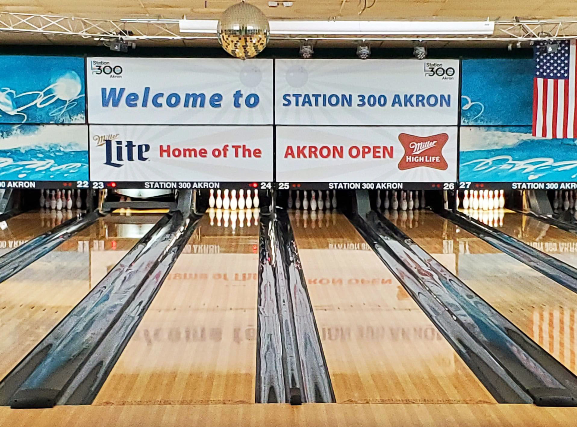 A photo of four large vinyl panels above bowling lanes at Station 300 in Cuyahoga Falls, Ohio.