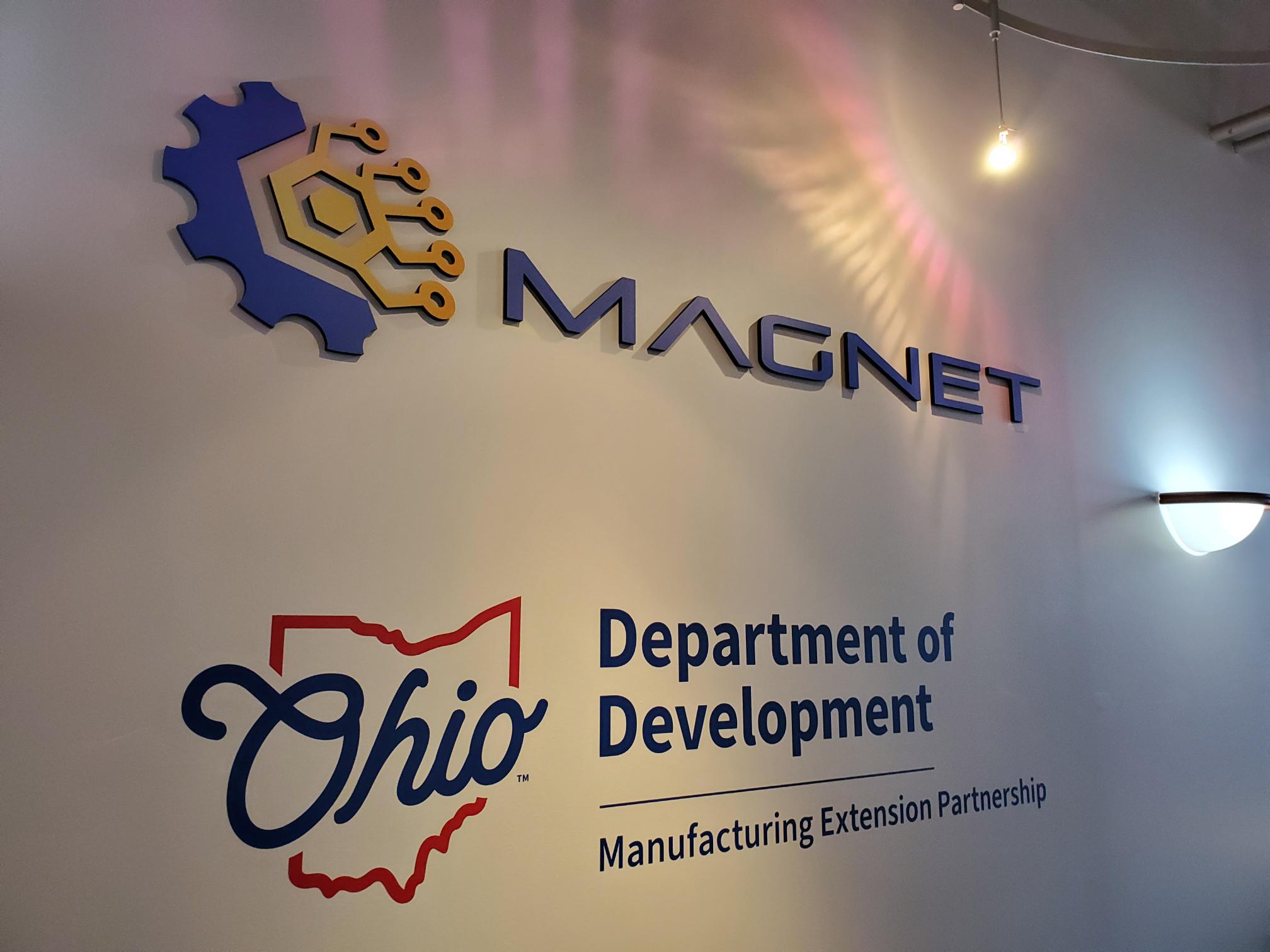 A photo of a dimensional sign depicting the MAGNET logo.
