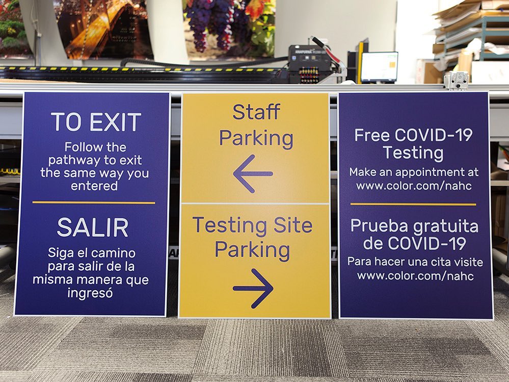 Covid-19 testing site directional signs for exits, staff parking, and free testing.