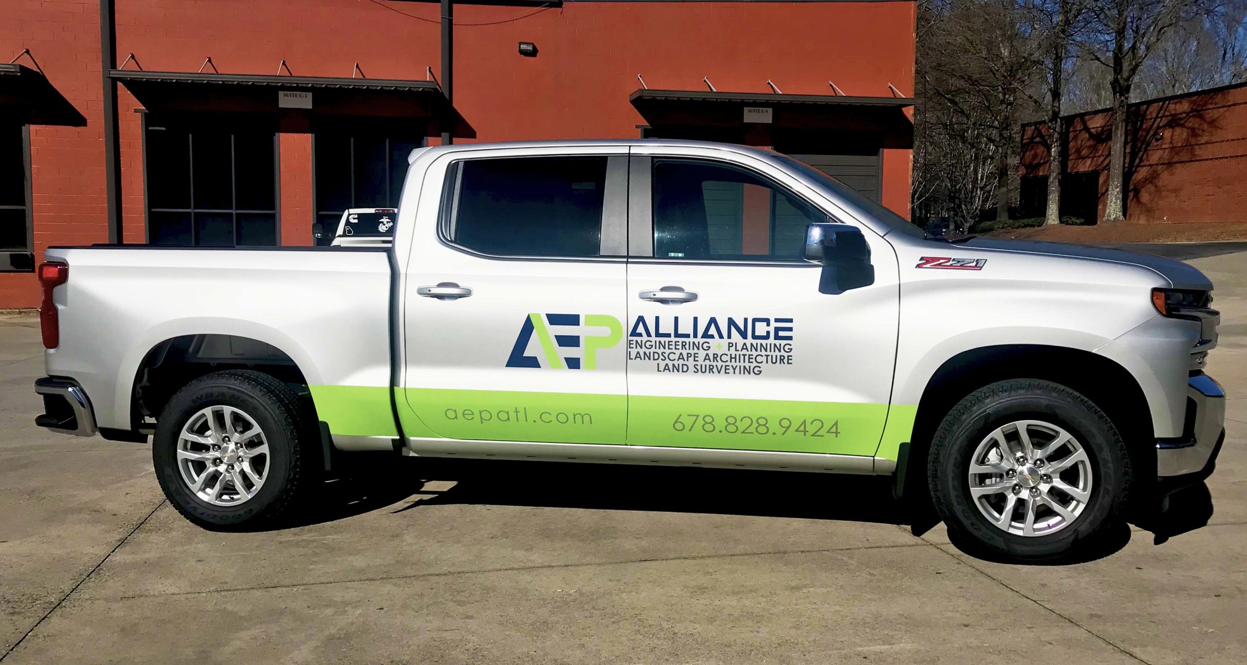 Silver pickup truck with vehicle decal for AEP Alliance engineering and planning landscape architecture land surveying