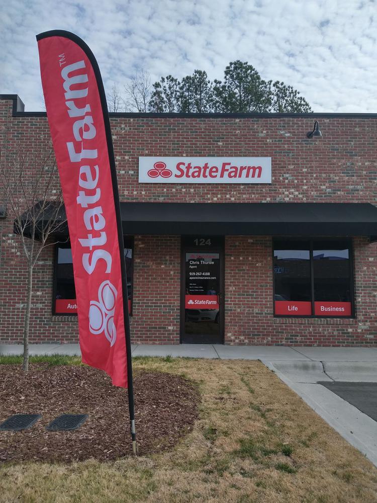 Outside entrance to State Farm with sign and flag
