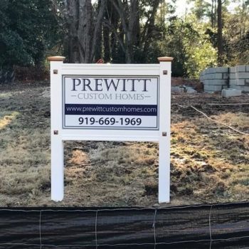Stand up wooden board advertising Prewitt Custom Homes - Email and Phone number