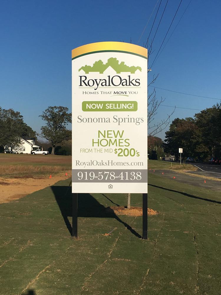 Tall advertisement sign for Royal Oaks