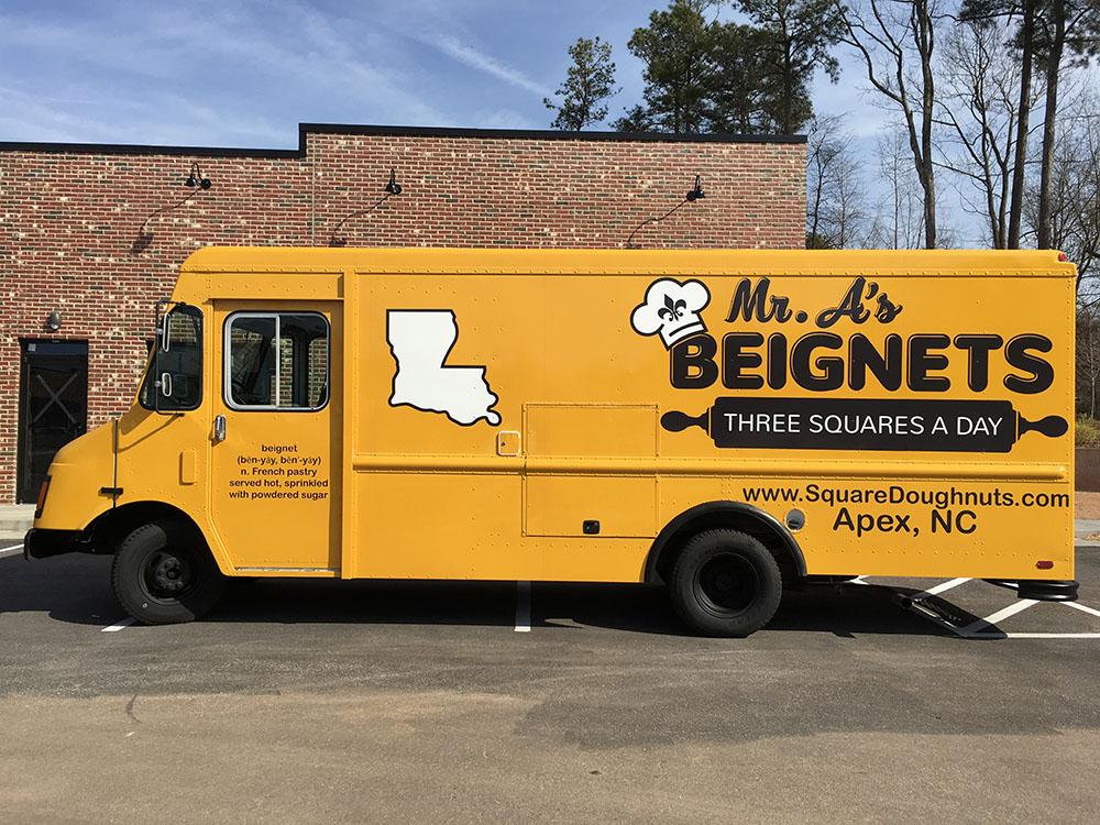 Side of Mr. A's Beignets advertised printed truck 
