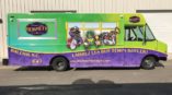 Bourbon Street Beignets green and purple advertisement van 