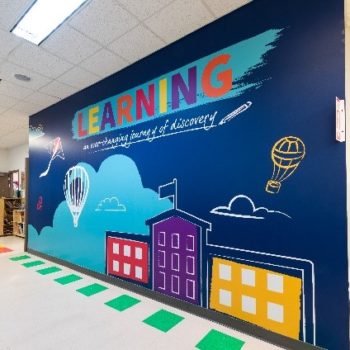 Wall graphic covering in school hallway encouraging learning 