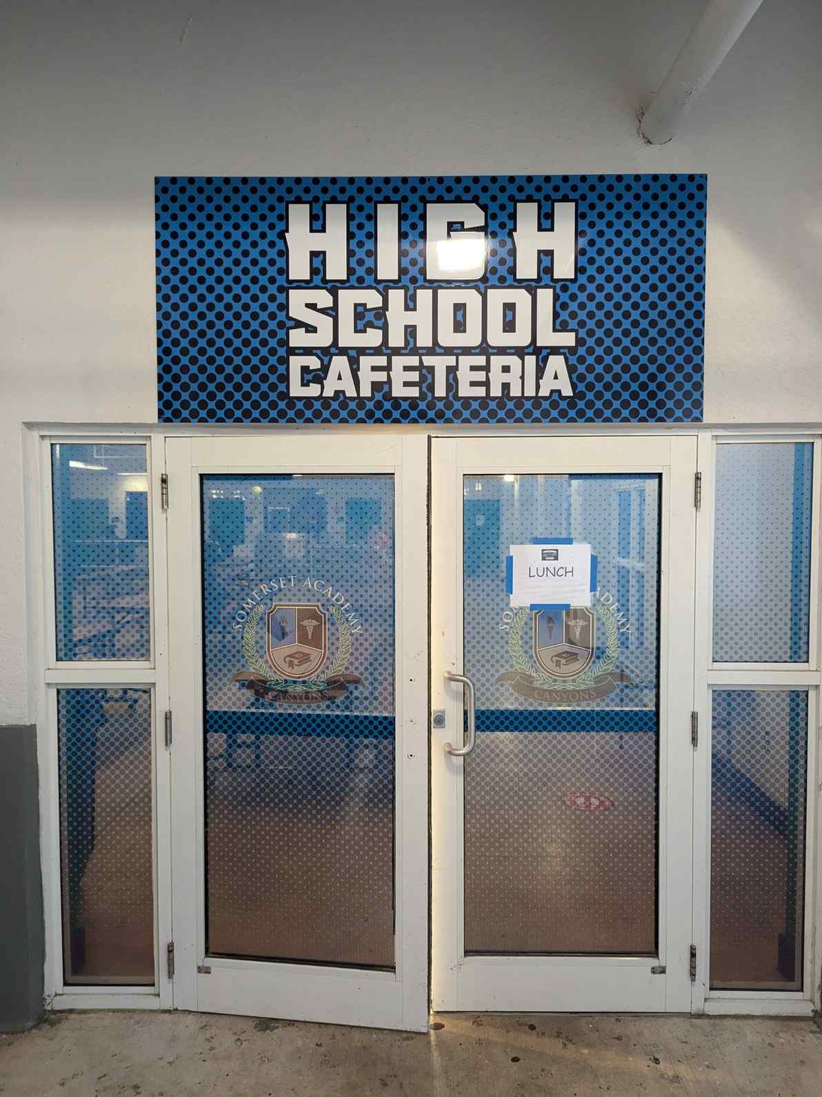 School cafeteria entrance with prominent outdoor signage