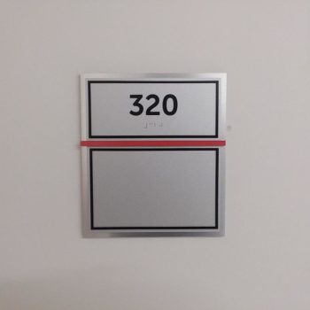 Room sign that says 320 in braille