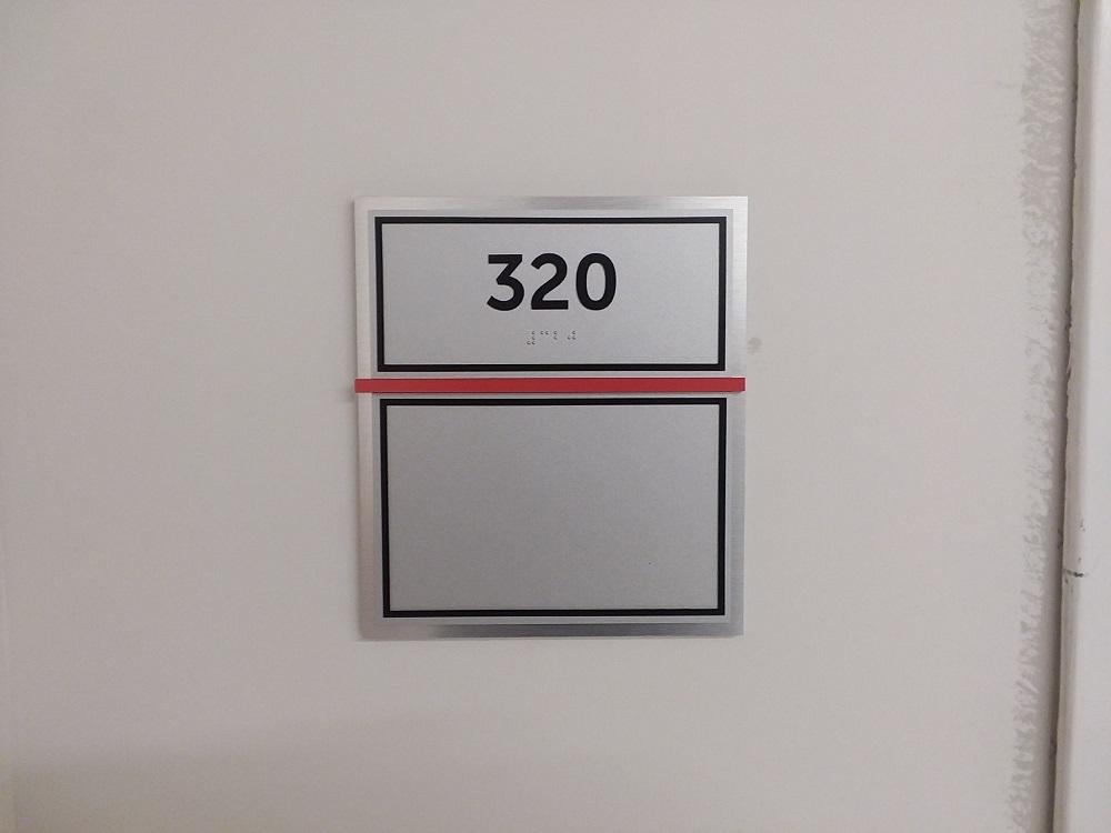 Room sign that says 320 in braille