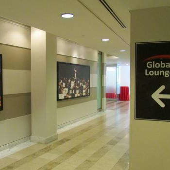 global lounge indoor sign pointing to other hung photos