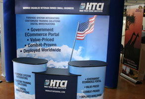 Custom tradeshow booth with graphics of HTCI logo and services. 