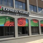 Express Yourself advertisement print over windows 