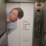 Elevator door graphic of a butler holding a silver trey.