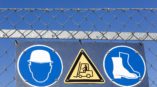 outdoor safety signs on barb wire fence 