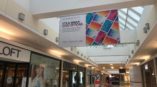 Simon gift card large hanging banner in a mall wing 