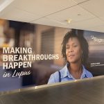 Large printed wall mural featuring a portrait and text graphics in Boston, Massachusetts.