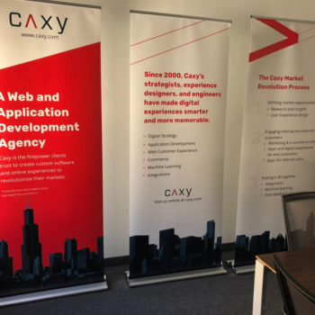 three promotional vinyl banners for CAXY