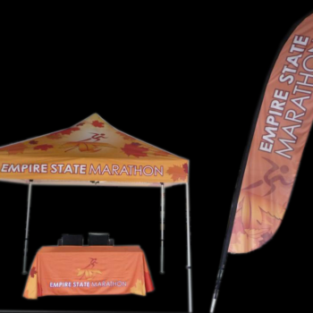 Table, tent and outside flag displaying cutom graphics for the Empire State Marathon.