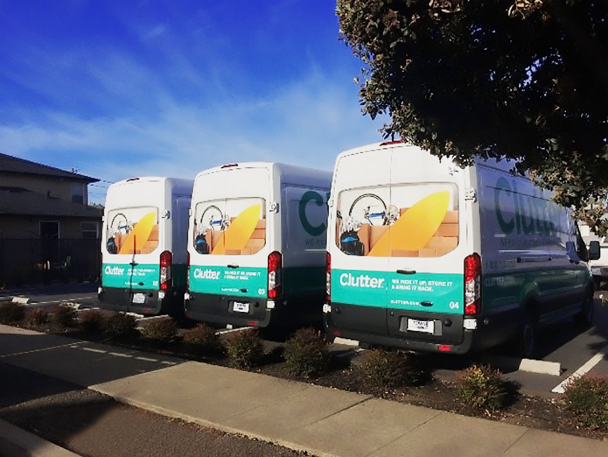 three vans with fleet wrap printed with Clutter logo