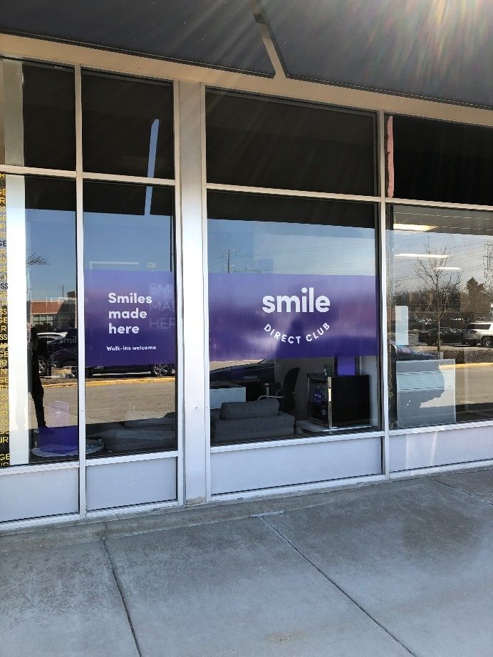 promotional window graphics for front door of Smile Direct