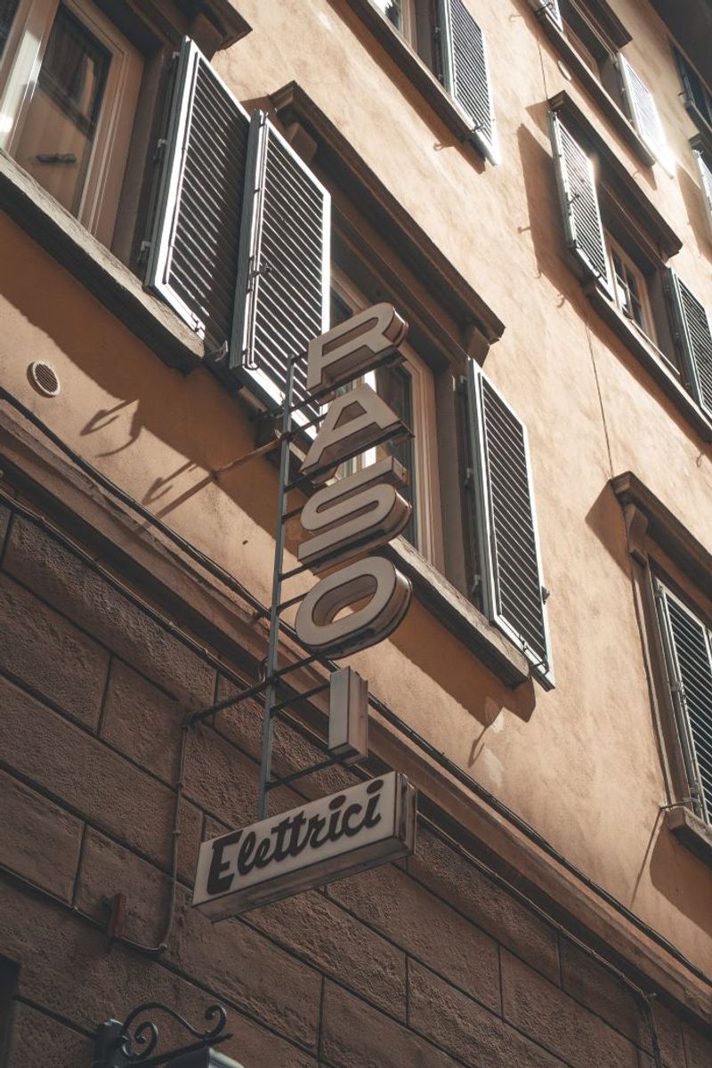 Brown metal Rasoi Elettrici sign with iron details