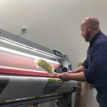 Man cleaning digital printing press