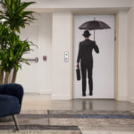 Man holding umbrella elevator wrap