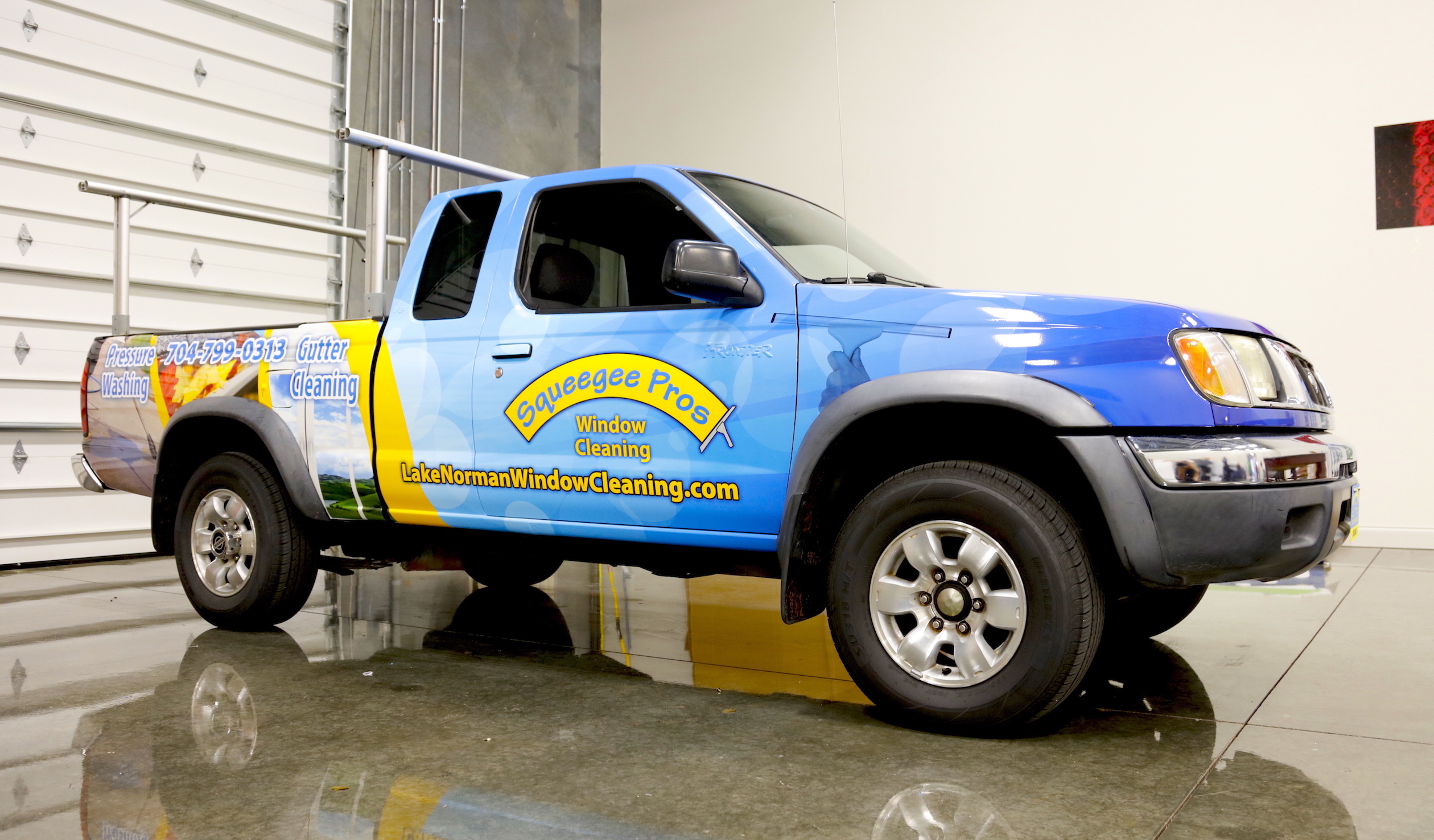 Squeegee Pros blue and yellow printed truck vehicle wrap