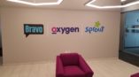 Wall graphics for company logos in an office waiting area.