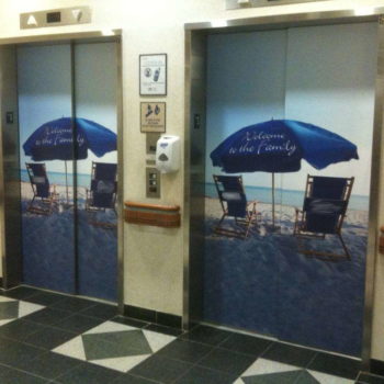 Elevator graphic of beach chairs in front of water