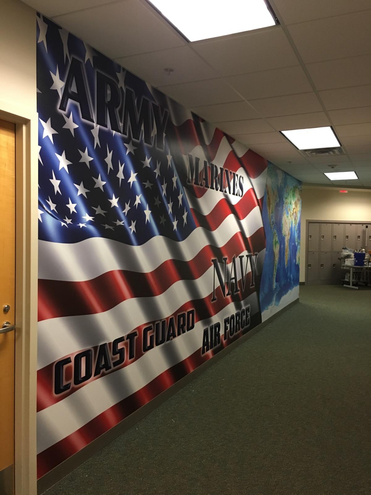 Wall mural showing an American flag and various military branches on an indoor wall