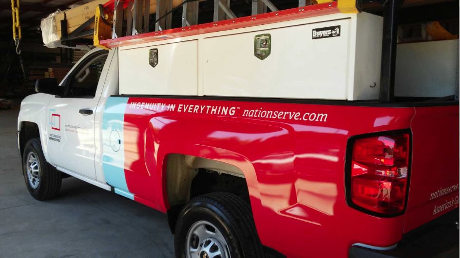 Red and white utility truck with custom car decals
