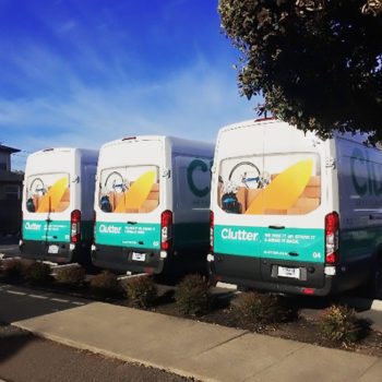three white vans with vehicle wraps for Clutter