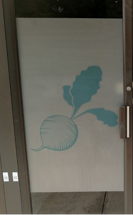 A glass etching of a beet on a glass door