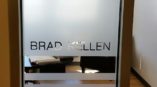 A frosted glass etching of a name on a door
