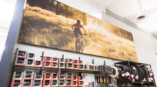 A retail graphic of a woman biking in nature on display at a store