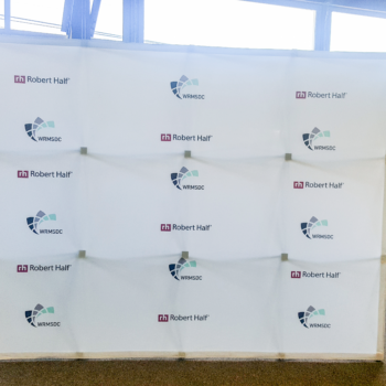 A step and repeat banner on display indoors