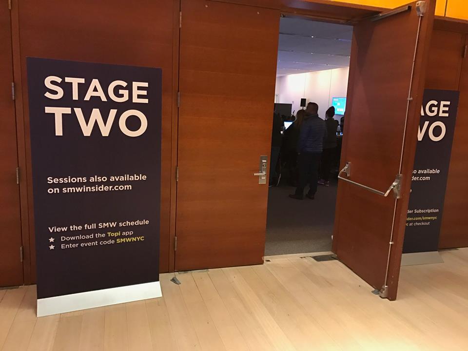 Freestanding fabric banner signage with metal base at event entrance in Chicago Downtown.