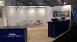 Tradeshow booth with fabric counters, frosted glass wall, and printed wall graphics in Chicago