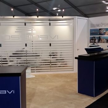 Tradeshow booth with fabric counters, frosted glass wall, and printed wall graphics in Chicago