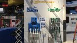 Trade show display wall with mounted dispensers and printed graphics in Chicago Downtown.