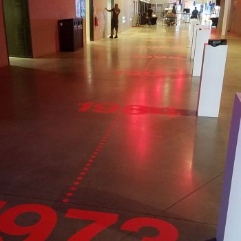 Red floor vinyl timeline decals displayed in an indoor event space in Chicago Downtown.