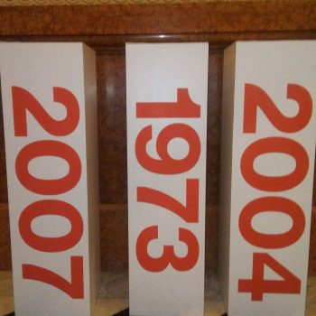 Three freestanding rectangular trade show displays with large red numbers in Chicago Downtown.