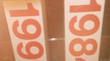 Two tall rectangular trade show display towers with large orange numbers in Chicago Downtown.